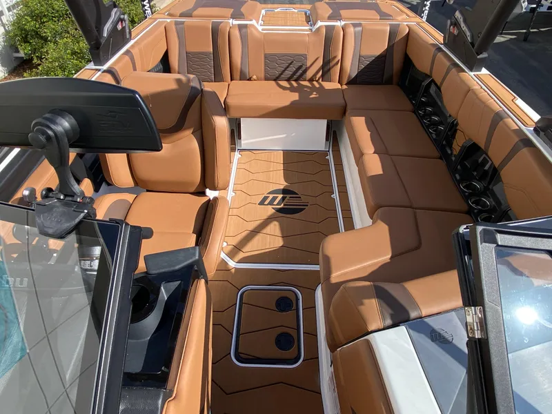 Slide: The Image of 2025 Malibu Wakesetter 22 MXZ interior with tan seating and modern design. - 12