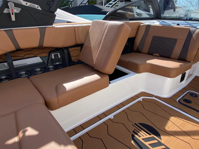 Slide: The Image of 2025 Malibu Wakesetter 22 MXZ interior with brown leather seating and modern design. - 13