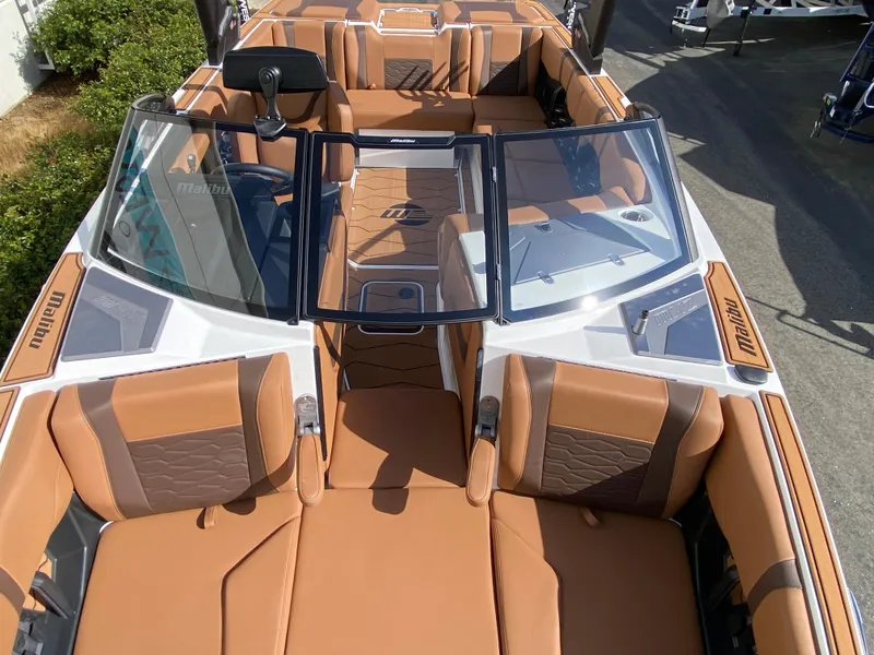 Slide: The Image of 2025 Malibu Wakesetter 22 MXZ boat with luxurious tan seating and sleek design. - 15