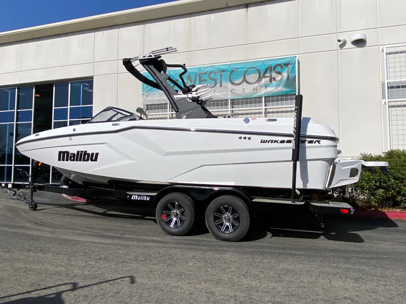 Slide: The Image of 2025 Malibu Wakesetter 22 MXZ boat on trailer outside West Coast dealership. - 3