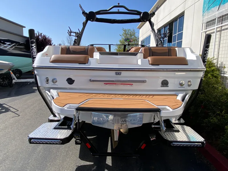 Slide: The Image of 2025 Malibu Wakesetter 22 MXZ boat, rear view, showcasing seating and swim platform. - 4