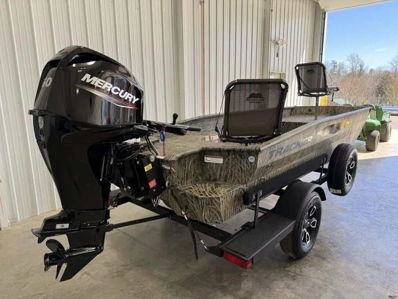 Slide: The Image of 2025 Tracker Grizzly® 1650 T Prairie Wings Edition boat with Mercury engine in a garage. - 3