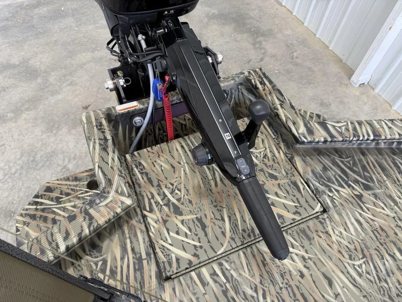 Slide: The Image of 2025 Tracker Grizzly® 1650 T Prairie Wings Edition with camouflage design and motor detail. - 8