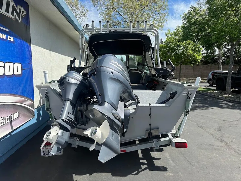 Slide: The Image of 2017 Smoker Craft 182 Phantom boat with dual outboard motors on a trailer. - 11