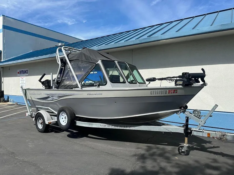 Slide: The Image of 2017 Smoker Craft 182 Phantom boat on trailer, parked outdoors. - 2