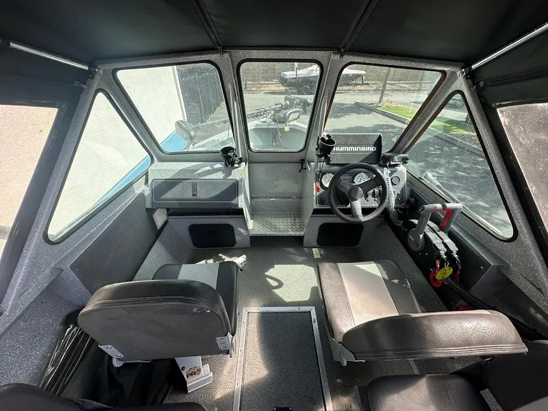 Slide: The Image of 2017 Smoker Craft 182 Phantom boat interior with steering wheel and seating arrangement. - 22