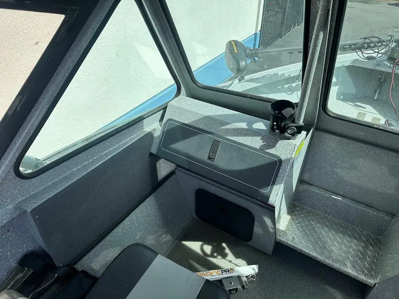 Slide: The Image of Interior of 2017 Smoker Craft 182 Phantom boat, featuring seating and dashboard area. - 24