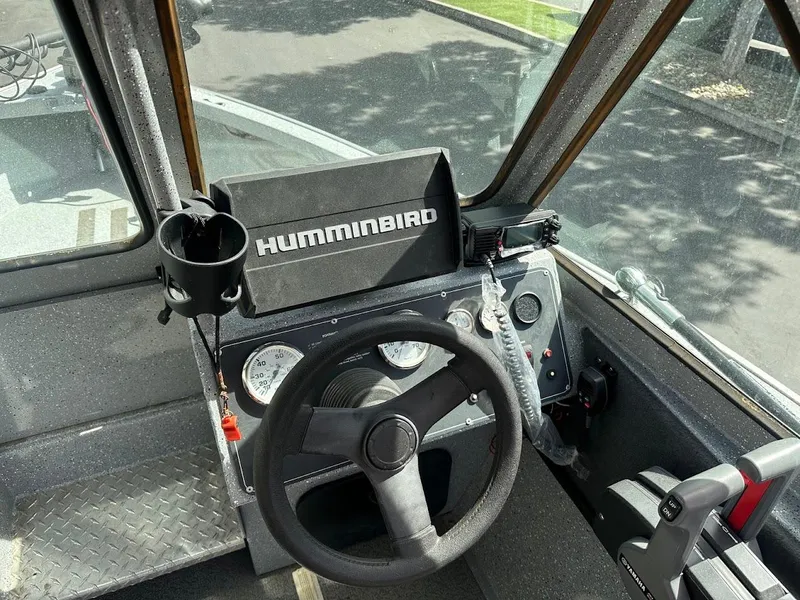 Slide: The Image of 2017 Smoker Craft 182 Phantom boat dashboard with Humminbird fish finder and steering wheel. - 27