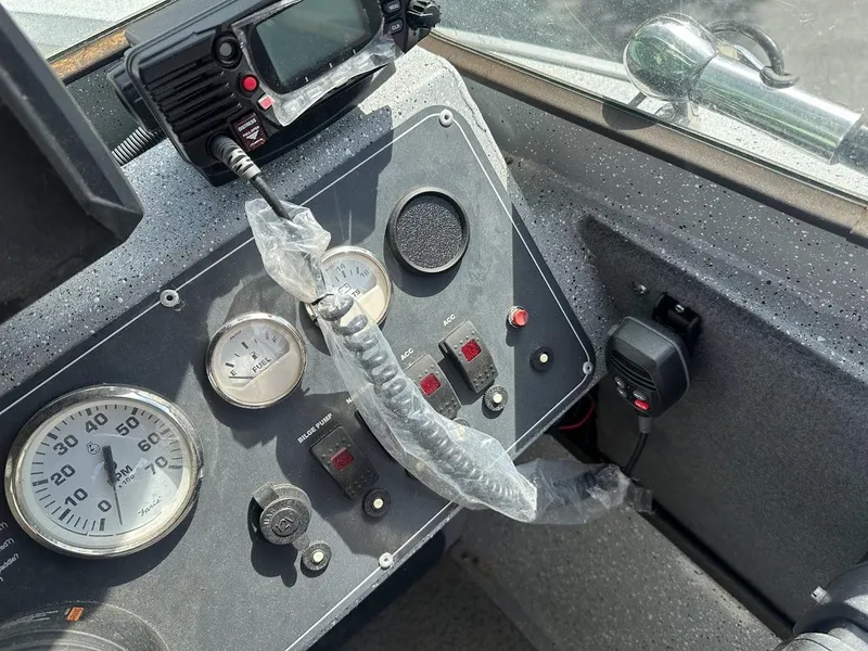 Slide: The Image of Control panel of 2017 Smoker Craft 182 Phantom boat with gauges and radio equipment. - 30