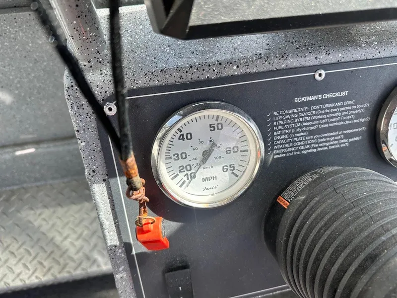 Slide: The Image of Dashboard of 2017 Smoker Craft 182 Phantom boat with speedometer and checklist. - 31