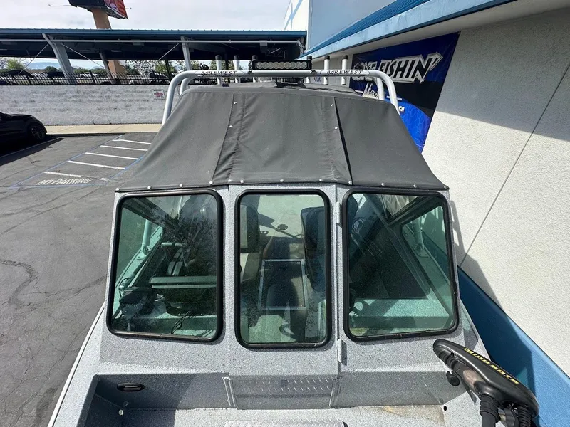 Slide: The Image of 2017 Smoker Craft 182 Phantom boat with covered windshield in parking lot. - 36