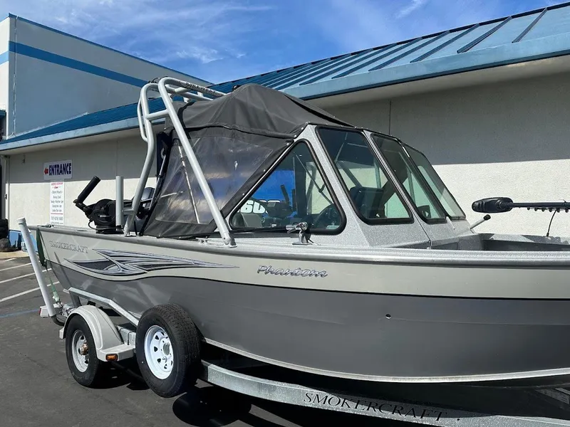 Slide: The Image of 2017 Smoker Craft 182 Phantom boat on trailer, parked outside a building. - 8