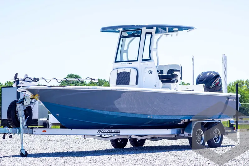 Slide: The Image of 2025 Tidewater 2410 Bay Max boat on trailer, side view, outdoors. - 1