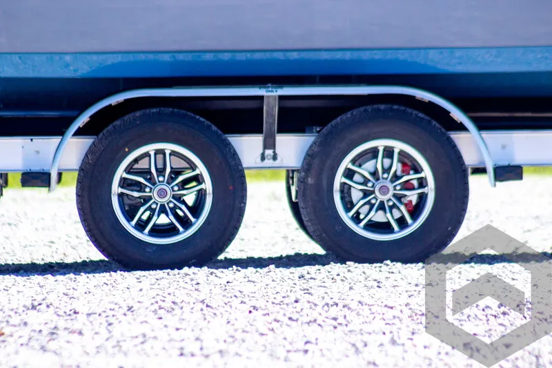Slide: The Image of Trailer wheels of a 2025 Tidewater 2410 Bay Max boat on gravel. - 11