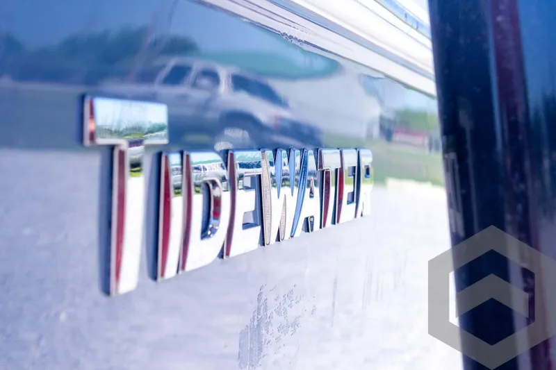 Slide: The Image of 2025 Tidewater 2410 Bay Max boat logo with reflective surface. - 15