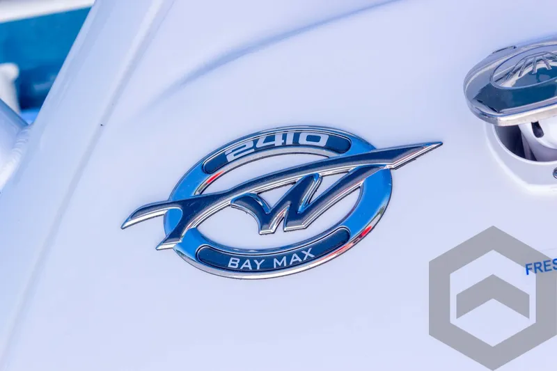 Slide: The Image of 2025 Tidewater 2410 Bay Max logo on a sleek white boat surface. - 16