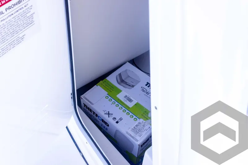 Slide: The Image of 2025 Tidewater 2410 Bay Max storage compartment with a boxed item inside. - 30