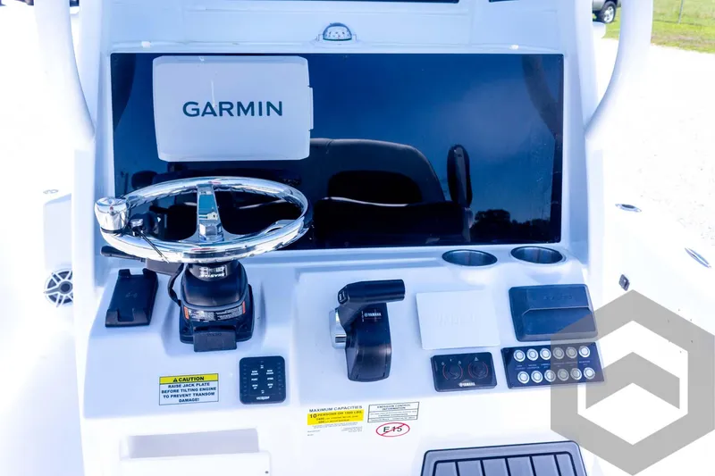 Slide: The Image of 2025 Tidewater 2410 Bay Max boat console with Garmin navigation system and controls. - 32