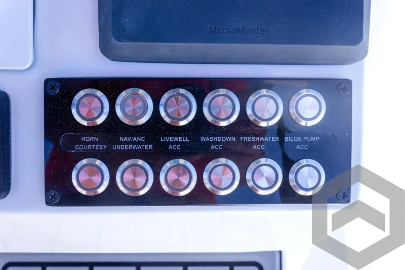 Slide: The Image of Control panel of 2025 Tidewater 2410 Bay Max boat with labeled buttons. - 34