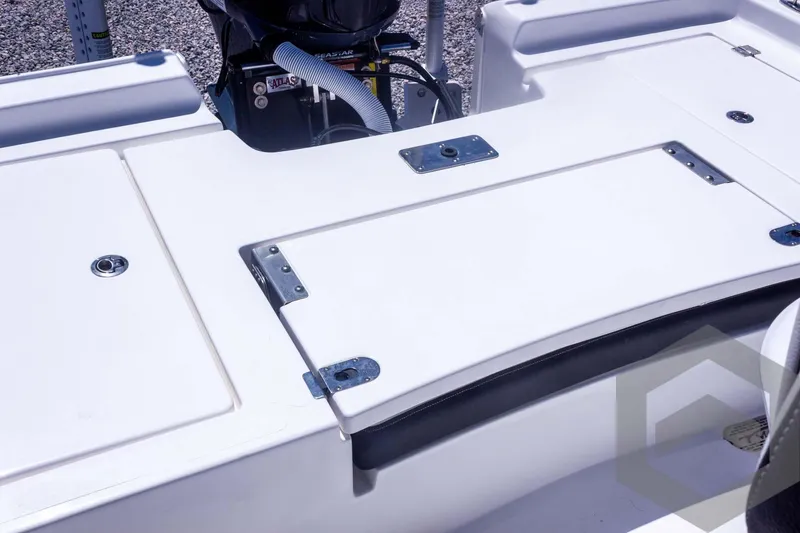 Slide: The Image of 2025 Tidewater 2410 Bay Max boat deck with storage compartments and engine details. - 43