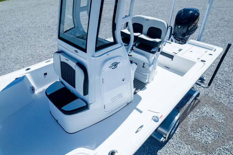 Slide: The Image of 2025 Tidewater 2410 Bay Max boat with center console and seating, displayed on gravel. - 49