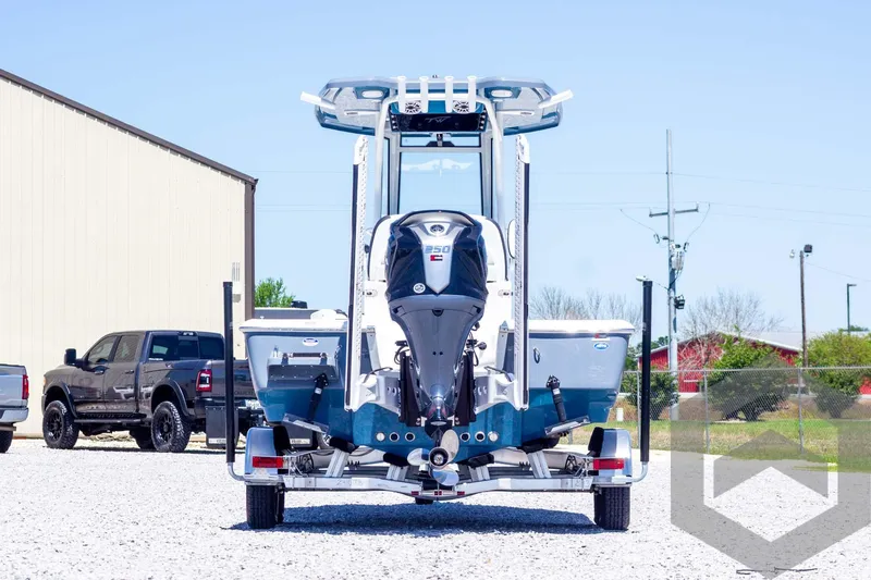 Slide: The Image of 2025 Tidewater 2410 Bay Max boat on trailer, rear view, parked outdoors. - 6