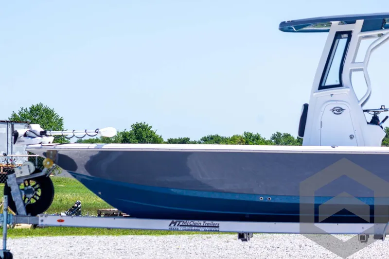 Slide: The Image of 2025 Tidewater 2410 Bay Max boat on trailer, side view, outdoors. - 8