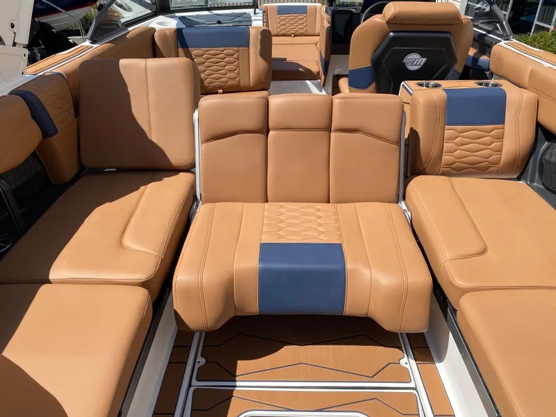 Slide: The Image of Luxurious interior of 2025 Malibu Wakesetter 24 MXZ with tan and blue seating. - 16