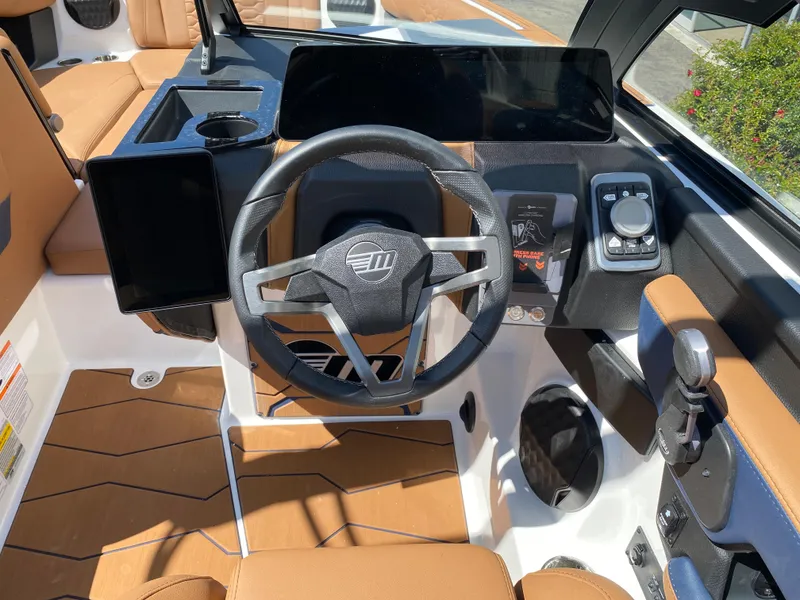 Slide: The Image of 2025 Malibu Wakesetter 24 MXZ dashboard with modern steering and controls. - 18