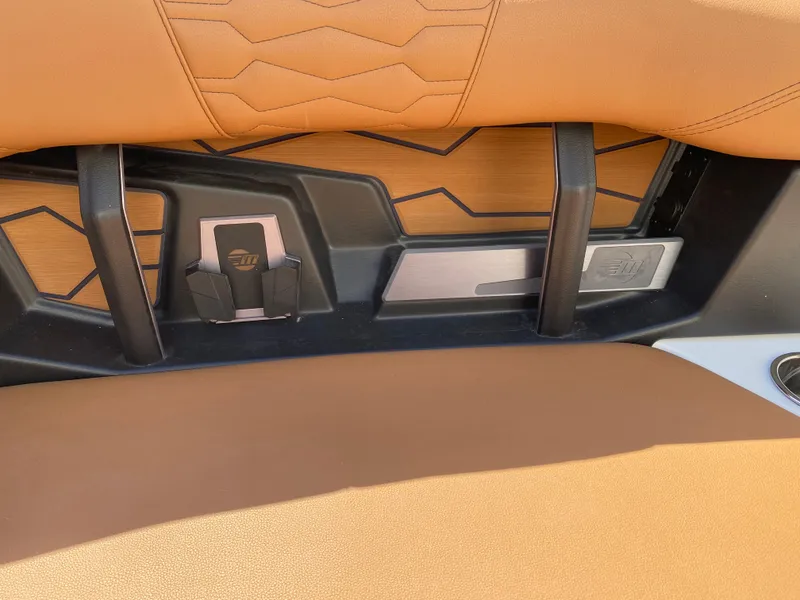 Slide: The Image of 2025 Malibu Wakesetter 24 MXZ interior with tan upholstery and sleek design elements. - 19
