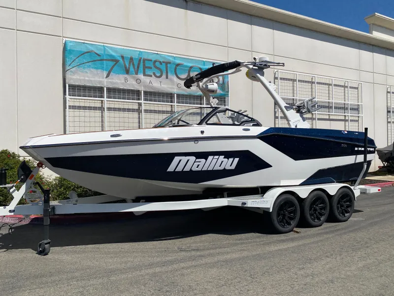 Slide: The Image of 2025 Malibu Wakesetter 24 MXZ boat on trailer at West Coast Boats dealership. - 2
