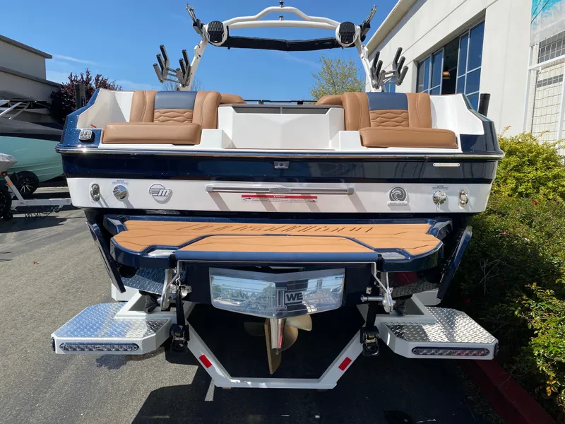 Slide: The Image of 2025 Malibu Wakesetter 24 MXZ boat, rear view, showcasing seating and swim platform. - 4