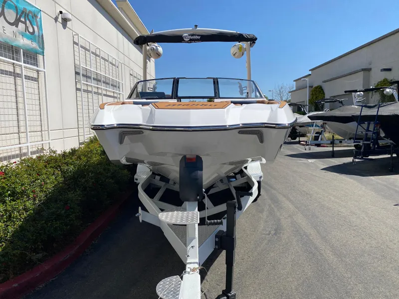 Slide: The Image of 2025 Malibu Wakesetter 24 MXZ boat on trailer, parked outdoors. - 5