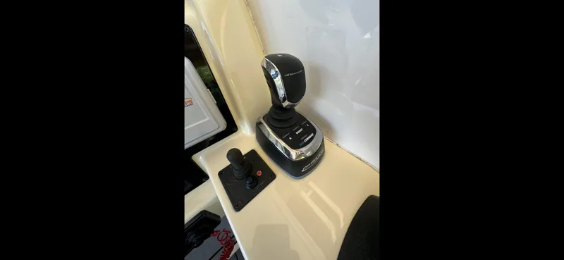 Slide: The Image of 2019 Regal 33 SAV boat controls with joystick and throttle lever. - 10