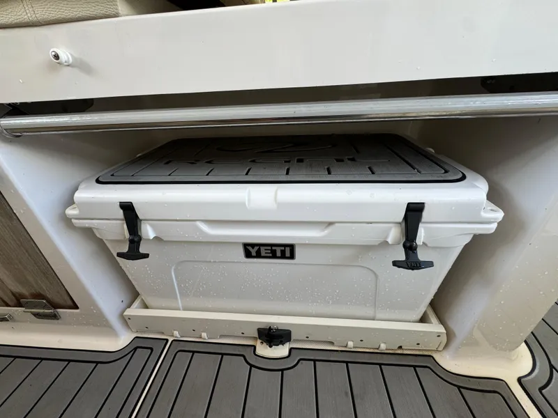 Slide: The Image of YETI cooler stored in a 2019 Regal 33 SAV boat compartment. - 13