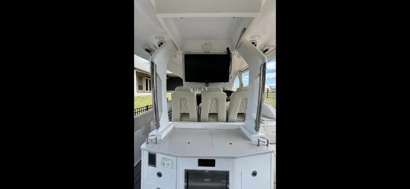 Slide: The Image of 2019 Regal 33 SAV boat interior with seating and mounted TV. - 14