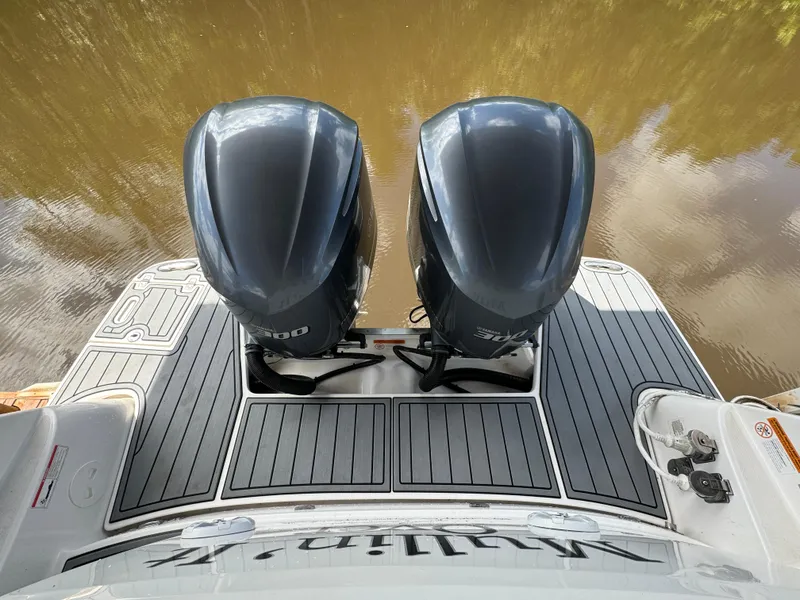 Slide: The Image of 2019 Regal 33 SAV boat with dual outboard engines on a calm water surface. - 23