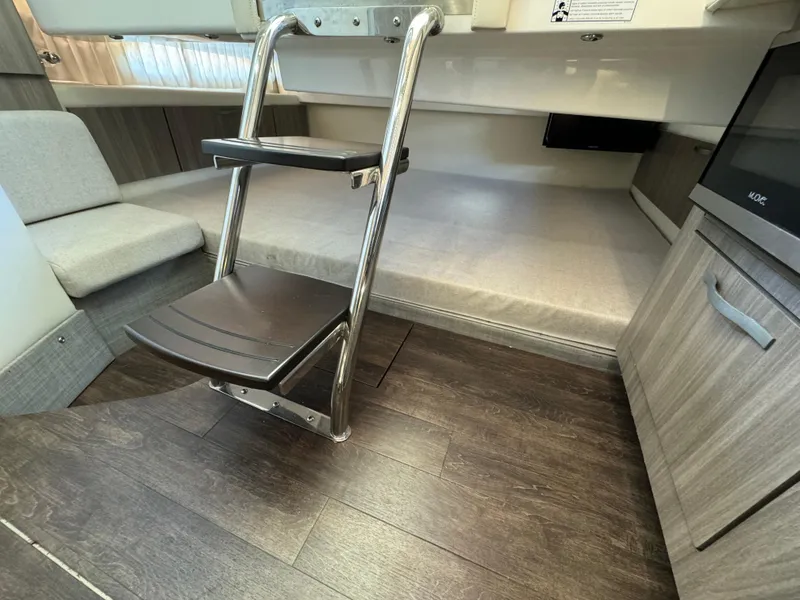 Slide: The Image of Interior of 2019 Regal 33 SAV boat with ladder and seating area. - 28