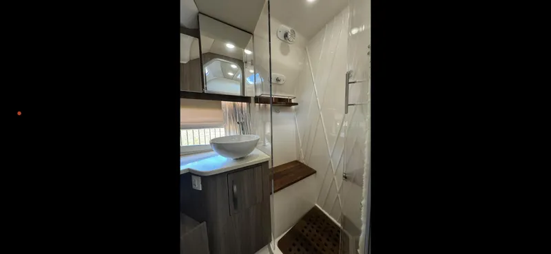 Slide: The Image of Modern bathroom in 2019 Regal 33 SAV boat with vessel sink and shower. - 29