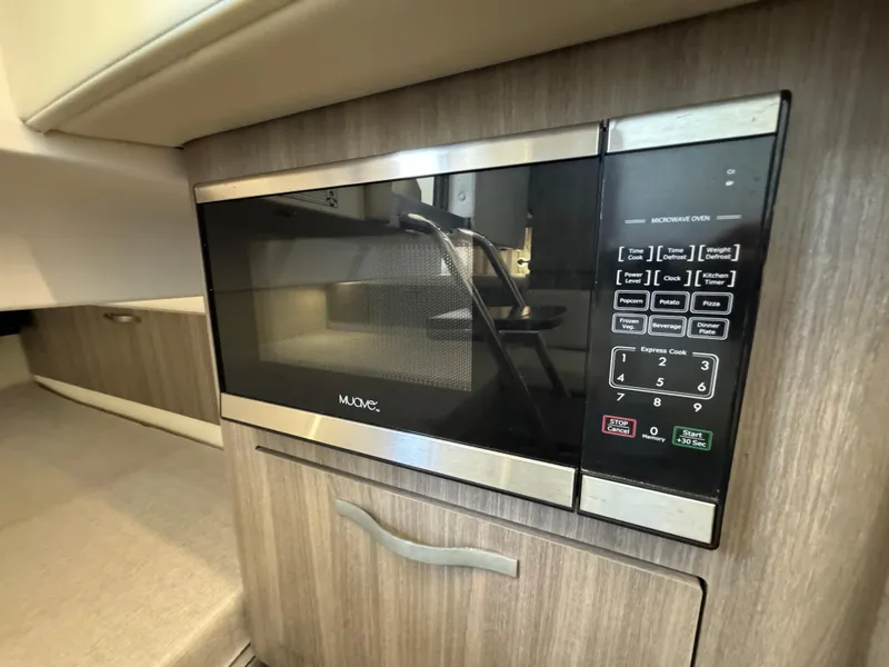 Slide: The Image of Built-in microwave in 2019 Regal 33 SAV boat interior. - 33