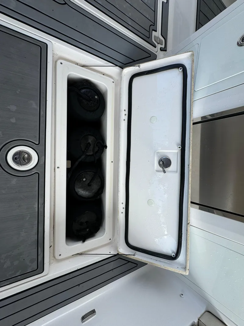 Slide: The Image of Open storage compartment on a 2019 Regal 33 SAV boat deck. - 37