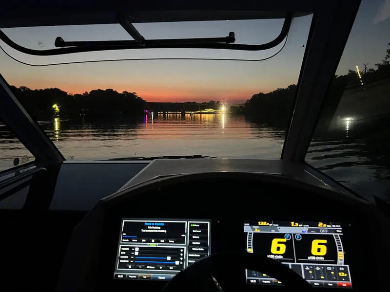 Slide: The Image of Cockpit view from a 2019 Regal 33 SAV boat at sunset on a calm river. - 39