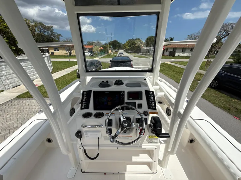 Slide: The Image of 2021 Robalo 246 Cayman SD boat console with steering wheel and controls. - 10