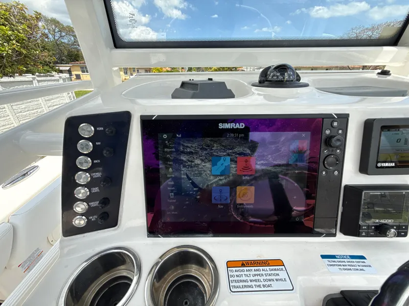 Slide: The Image of Helm of 2021 Robalo 246 Cayman SD with Simrad display and controls. - 11