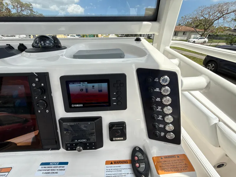 Slide: The Image of Control panel of 2021 Robalo 246 Cayman SD boat with Yamaha display and controls. - 12