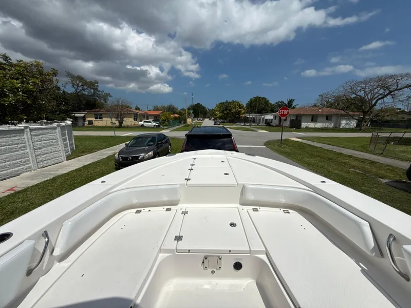 Slide: The Image of 2021 Robalo 246 Cayman SD boat on trailer in suburban neighborhood. - 15