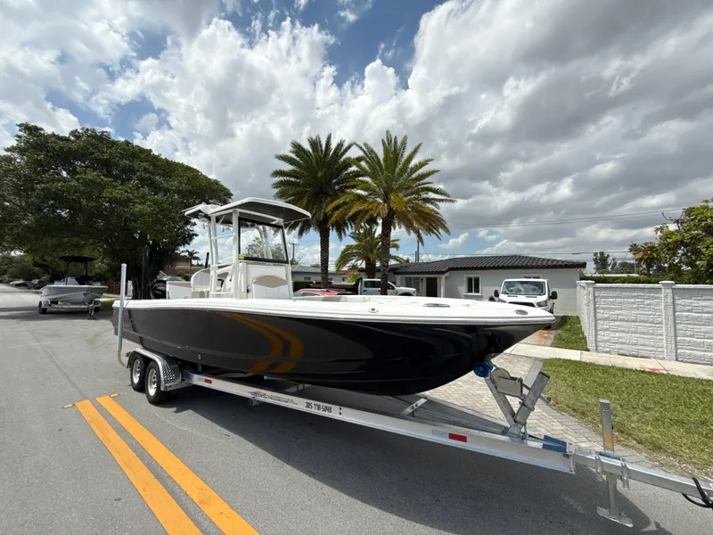 Slide: The Image of 2021 Robalo 246 Cayman SD boat on trailer, parked on suburban street. - 4