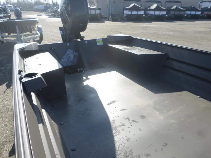 Slide: The Image of 2025 Alweld 1856 VV Marsh boat interior with motor, parked outdoors. - 7