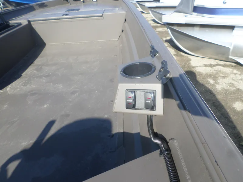Slide: The Image of 2025 Alweld 1648 VV Marsh boat interior with control switches and cup holder. - 3