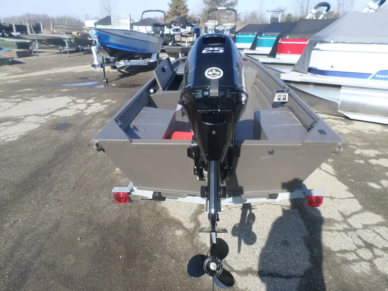 Slide: The Image of 2025 Alweld 1648 VV Marsh boat with 25 HP outboard motor, parked on a trailer. - 4